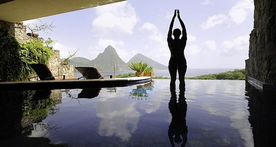 a silhoutte of a woman about to dive in the water